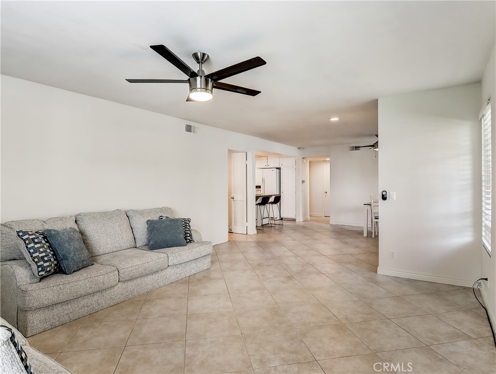 98 Greenfield, Unit 95 Irvine, CA 92614 - Photo 4 of 48 a living room with furniture and a ceiling fan