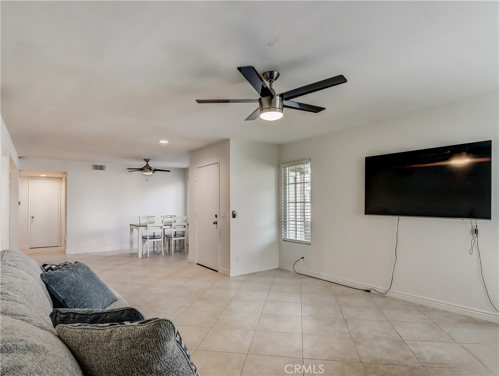 98 Greenfield, Unit 95 Irvine, CA 92614 - Photo 5 of 48 a living room with furniture and a flat screen tv