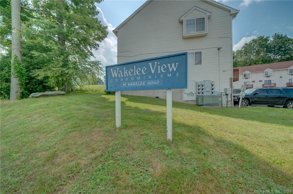 66 Wakelee Road, Unit 11 Waterbury, CT 06705 - Photo 1 of 1 a view of an house with backyard and trees