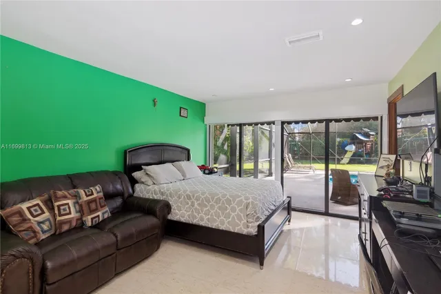 a bedroom with a bed and a large window