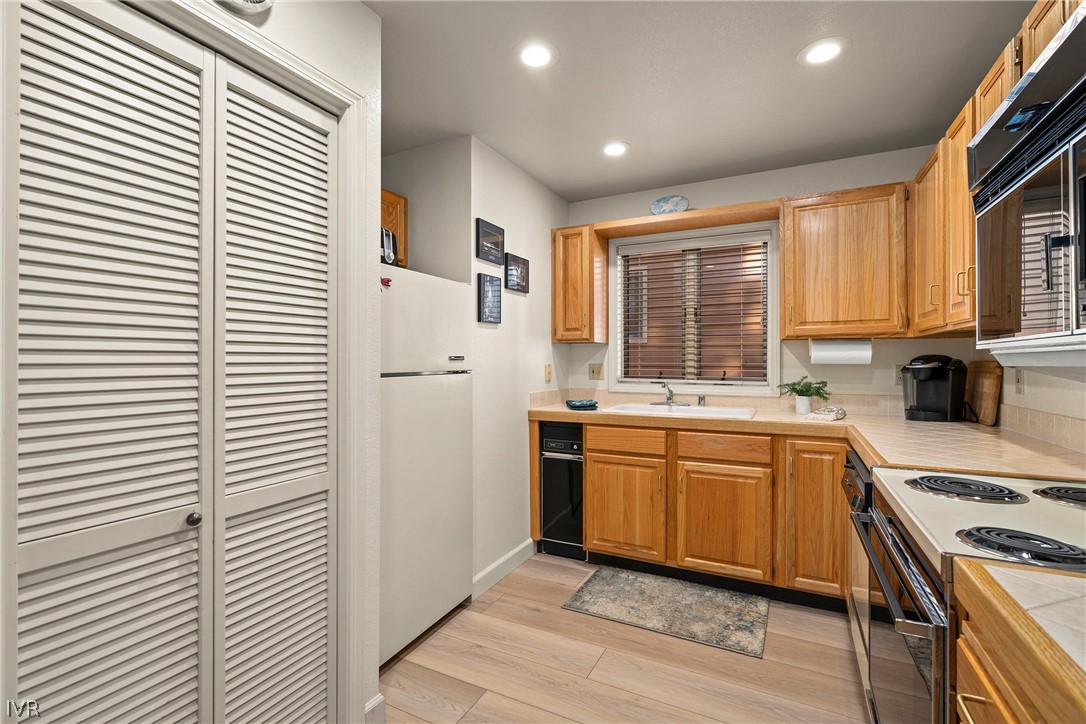 931 Incline Way, Unit 230 Incline Village, NV 89451 - Photo 13 of 24 a kitchen with stainless steel appliances granite countertop a stove a sink and a refrigerator