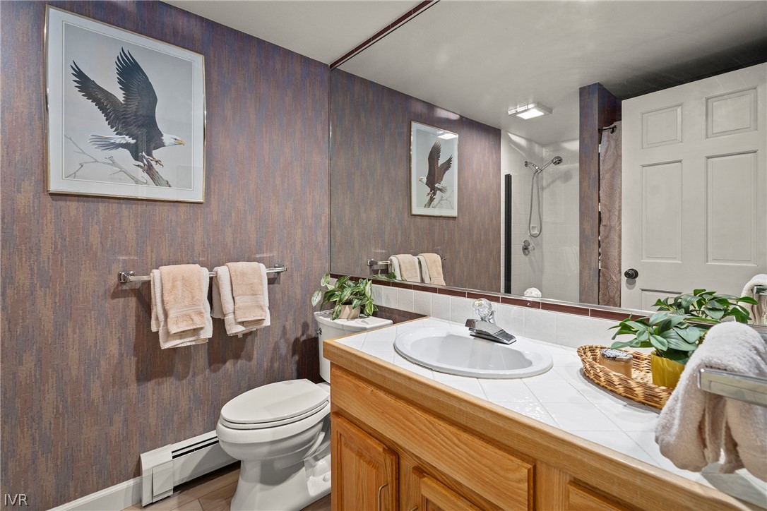 931 Incline Way, Unit 230 Incline Village, NV 89451 - Photo 19 of 24 a bathroom with a toilet sink and mirror