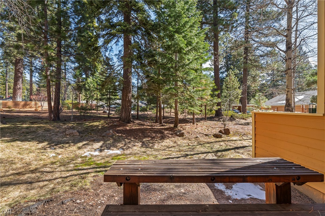 931 Incline Way, Unit 230 Incline Village, NV 89451 - Photo 7 of 24 a view of a backyard with wooden fence and large trees