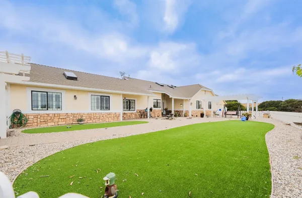 a view of house with a big yard