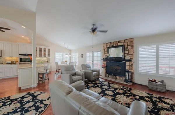a living room with furniture a flat screen tv and a fireplace