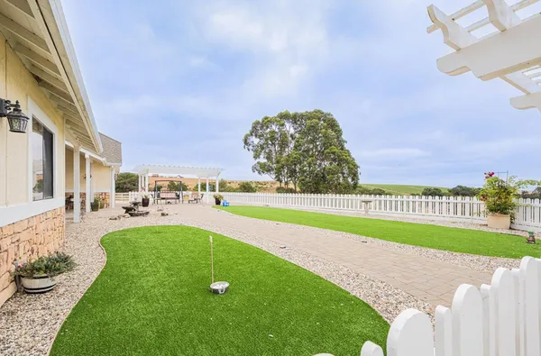 a view of a swimming pool and a yard