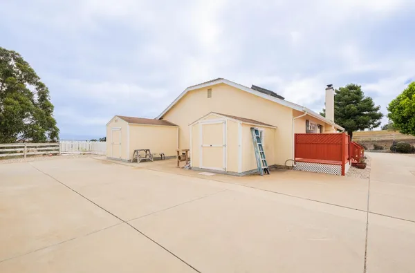 an aerial view of a house with a yard and lake view