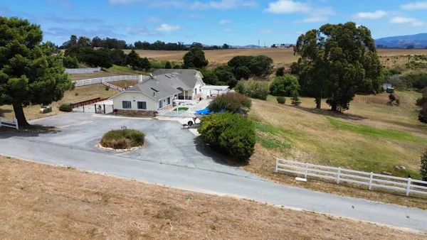 an aerial view of a house with a yard basket ball court and outdoor seating