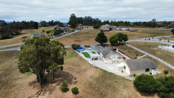 an aerial view of a house with outdoor space swimming pool and lake view