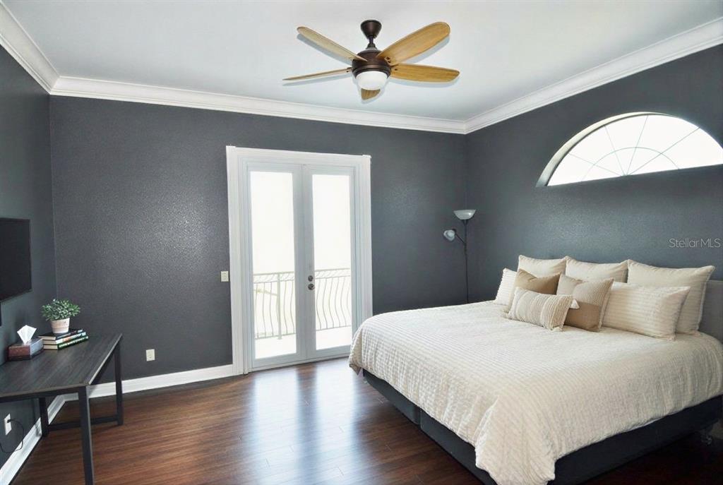 3605 Stabile Road St. James City, FL 33956 - Photo 14 of 95 a bedroom with a bed and a chandelier