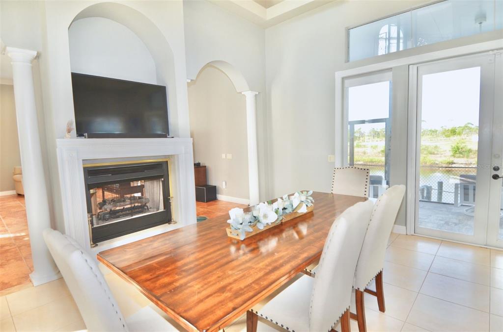 3605 Stabile Road St. James City, FL 33956 - Photo 26 of 95 a living room with furniture a flat screen tv and a fireplace