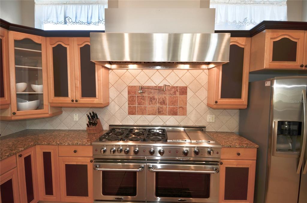 3605 Stabile Road St. James City, FL 33956 - Photo 32 of 95 a kitchen with granite countertop a stove and a sink