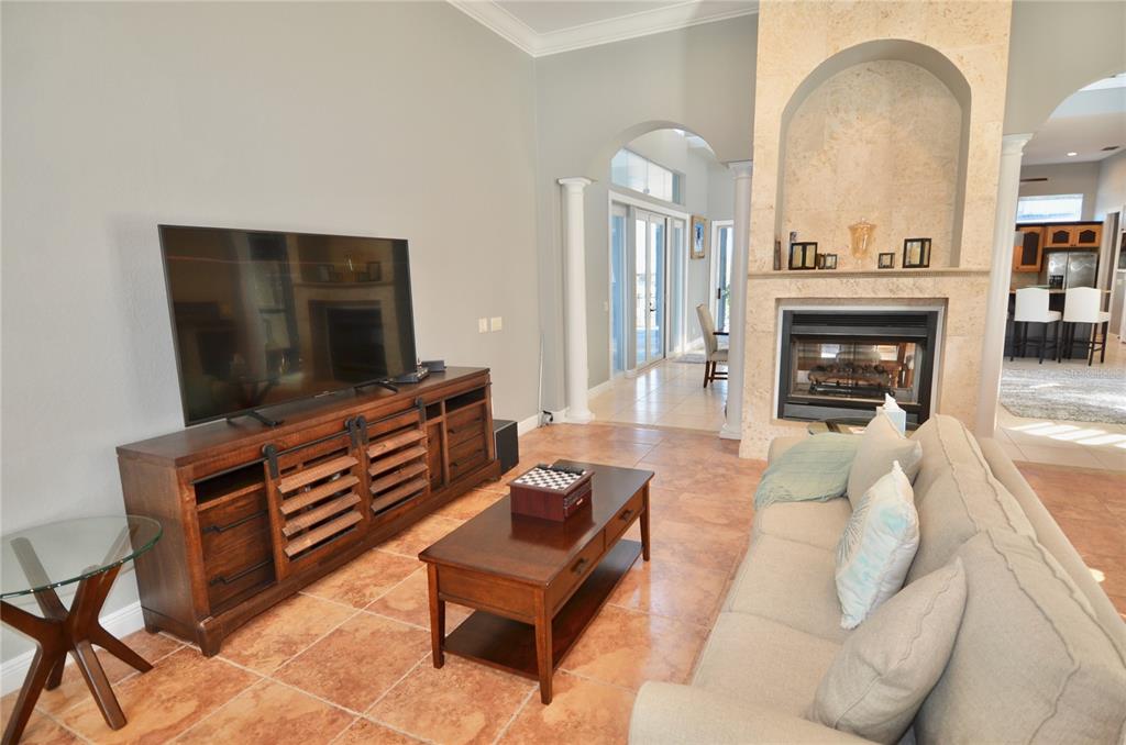 3605 Stabile Road St. James City, FL 33956 - Photo 36 of 95 a living room with furniture a fireplace and a flat screen tv