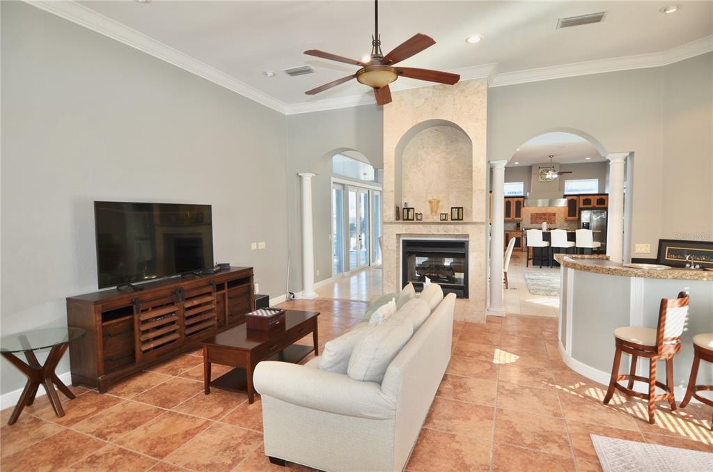 3605 Stabile Road St. James City, FL 33956 - Photo 37 of 95 a living room with furniture a fireplace and a flat screen tv