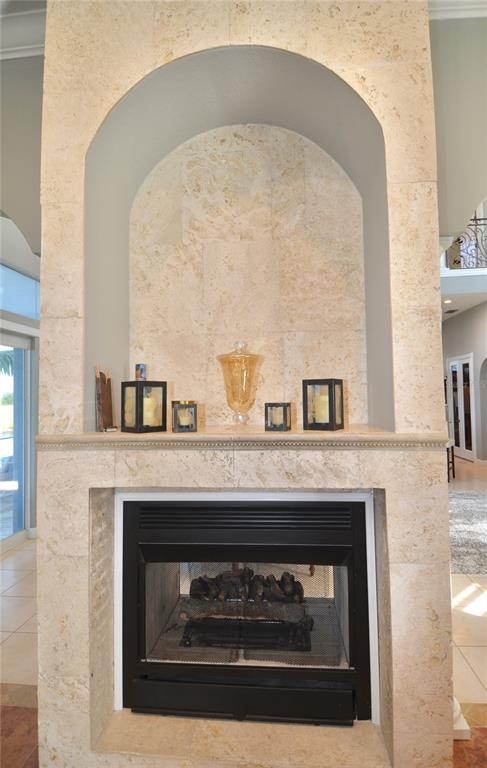 3605 Stabile Road St. James City, FL 33956 - Photo 40 of 95 a fireplace with a clock on top of it