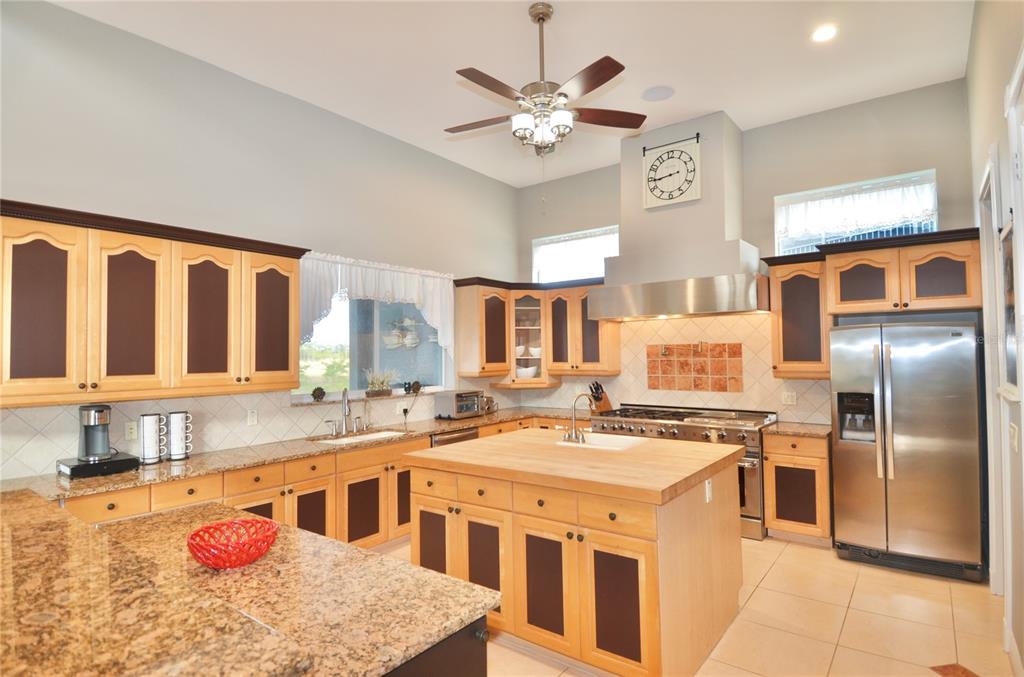 3605 Stabile Road St. James City, FL 33956 - Photo 4 of 95 a kitchen that has a lot of cabinets in it and wooden floors