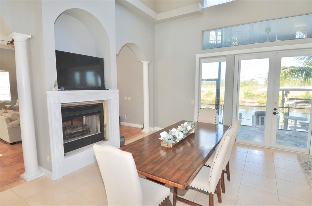 3605 Stabile Road St. James City, FL 33956 - Photo 5 of 95 a living room with furniture a flat screen tv and a fireplace