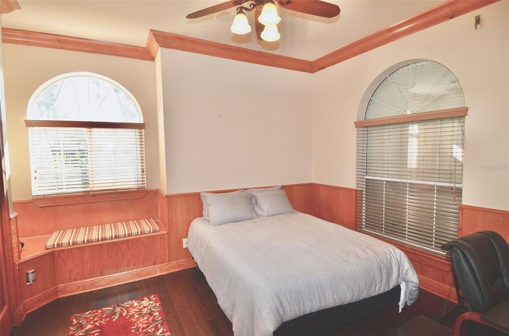 3605 Stabile Road St. James City, FL 33956 - Photo 52 of 95 a bedroom with a bed a mirror and a window