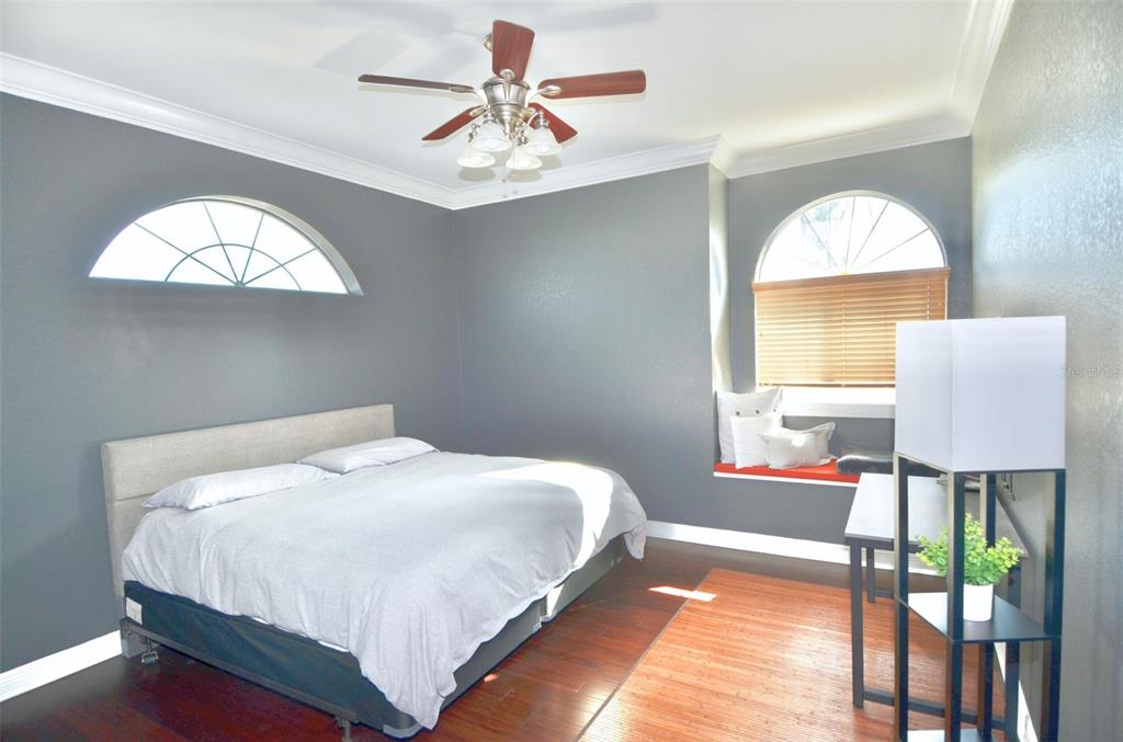 3605 Stabile Road St. James City, FL 33956 - Photo 53 of 95 a bedroom with a bed and a chandelier