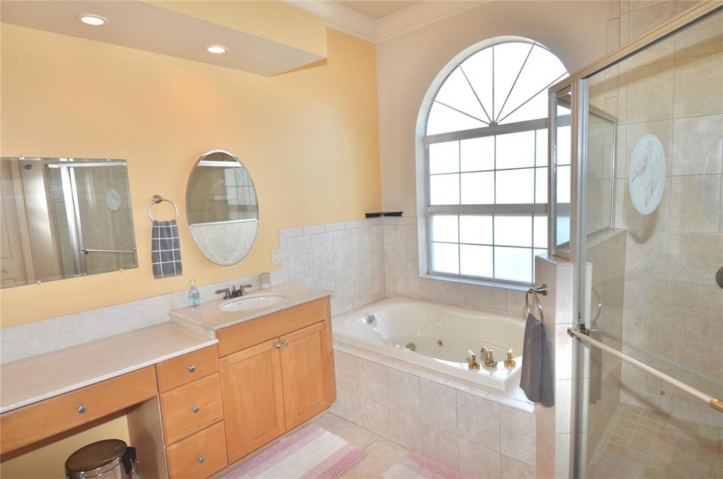 3605 Stabile Road St. James City, FL 33956 - Photo 54 of 95 a spacious bathroom with a tub sink and mirror