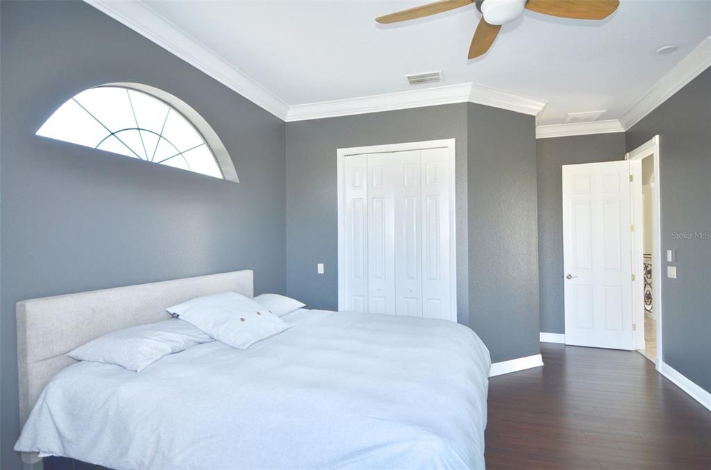 3605 Stabile Road St. James City, FL 33956 - Photo 55 of 95 a bedroom with a bed and a chandelier