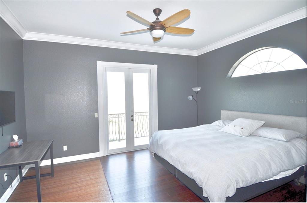 3605 Stabile Road St. James City, FL 33956 - Photo 56 of 95 a bedroom with a bed and a chandelier