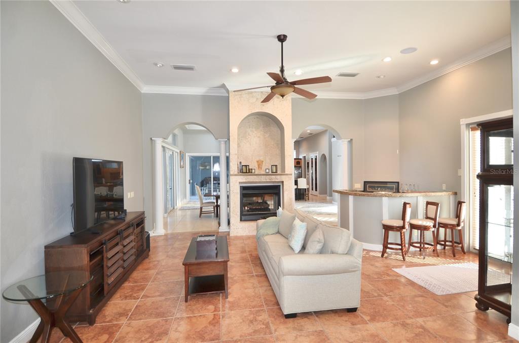 3605 Stabile Road St. James City, FL 33956 - Photo 6 of 95 a living room with furniture a fireplace and a flat screen tv