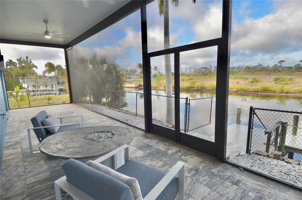 3605 Stabile Road St. James City, FL 33956 - Photo 68 of 95 a view of a living room with furniture and floor to ceiling windows