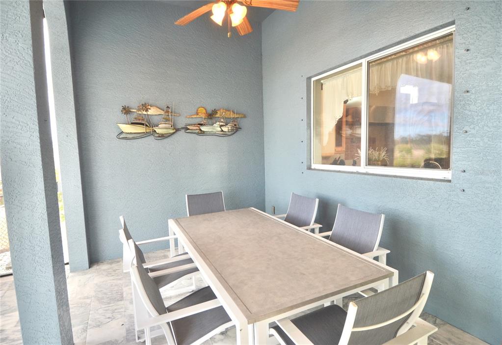3605 Stabile Road St. James City, FL 33956 - Photo 70 of 95 a view of a dining room with furniture and chandelier