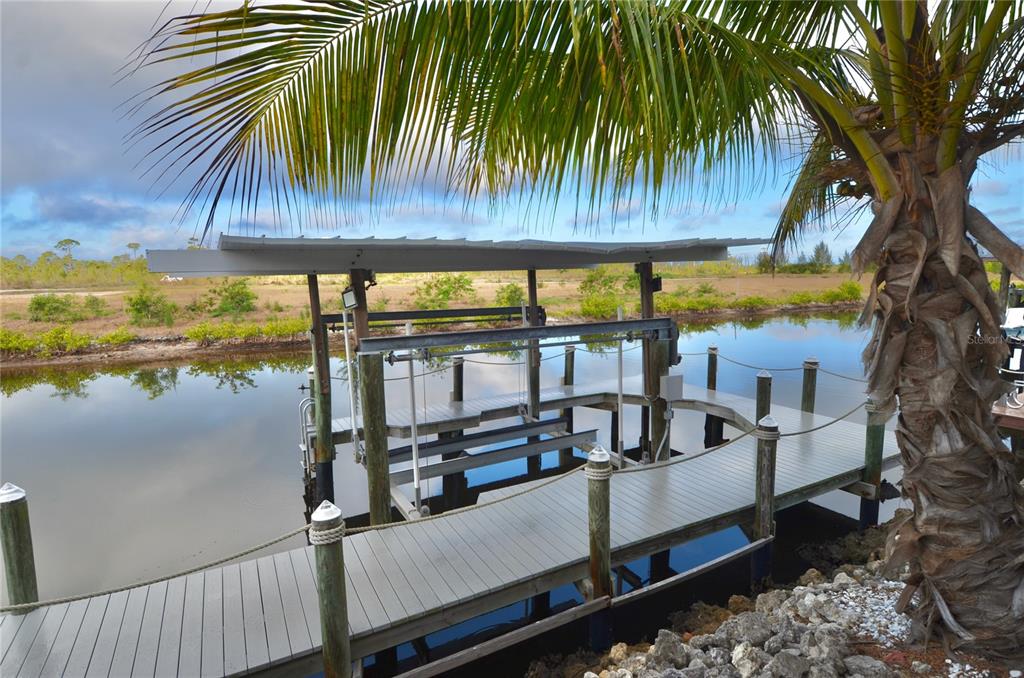 3605 Stabile Road St. James City, FL 33956 - Photo 71 of 95 a view of a swimming pool with a table and chairs