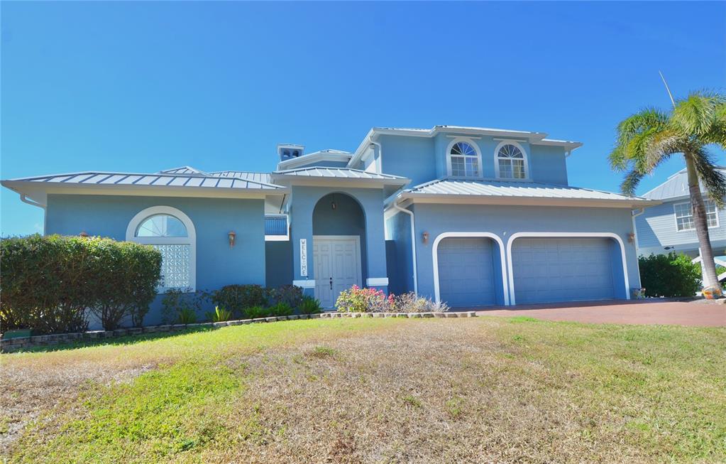 3605 Stabile Road St. James City, FL 33956 - Photo 87 of 95 a front view of a house with a yard and garage