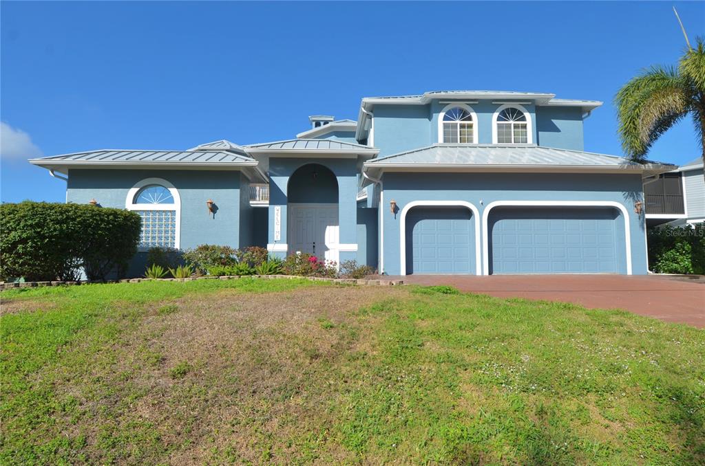 3605 Stabile Road St. James City, FL 33956 - Photo 89 of 95 a front view of a house with yard and garage