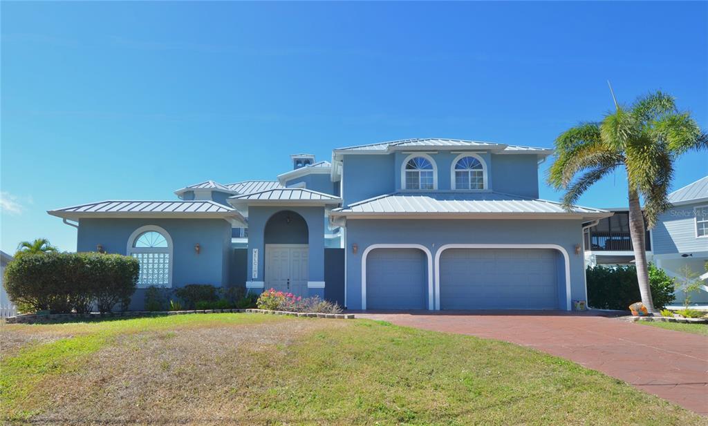 3605 Stabile Road St. James City, FL 33956 - Photo 91 of 95 a front view of a house with a yard and garage