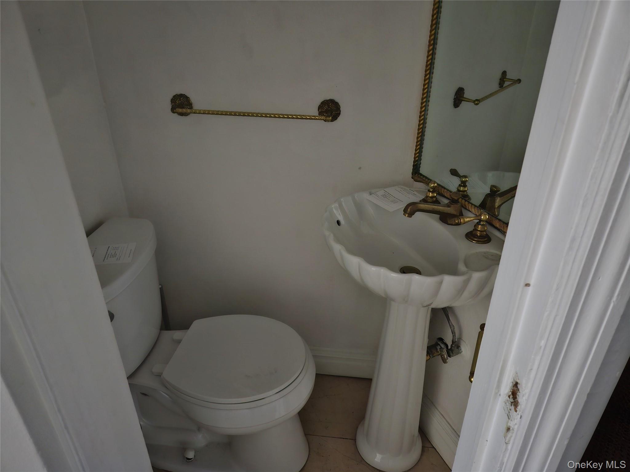 231 East 62nd Street Manhattan, NY 10065 - Photo 7 of 17 Bathroom with toilet and tile patterned flooring