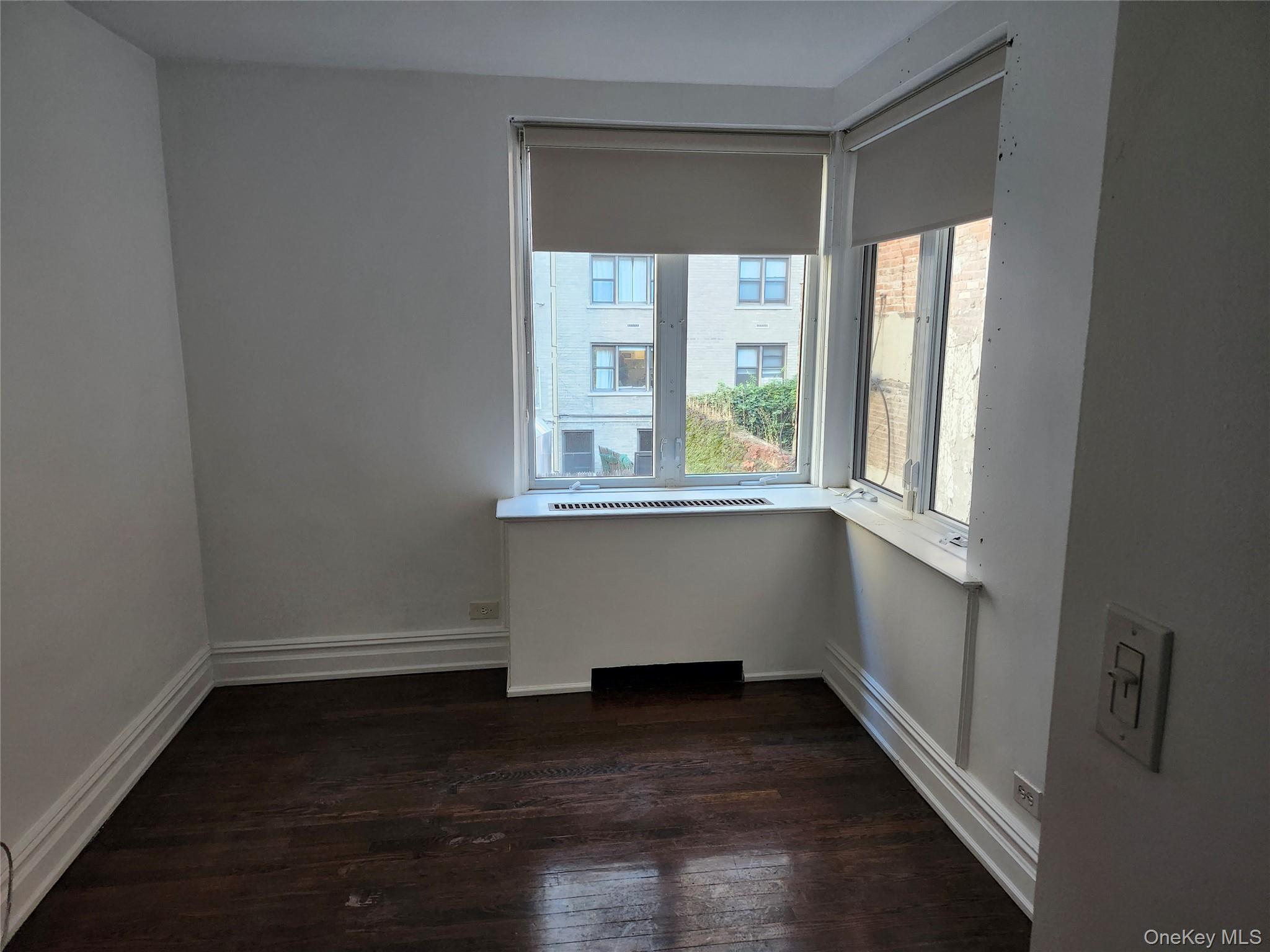 231 East 62nd Street Manhattan, NY 10065 - Photo 8 of 17 Unfurnished bedroom with dark wood finished floors and baseboards