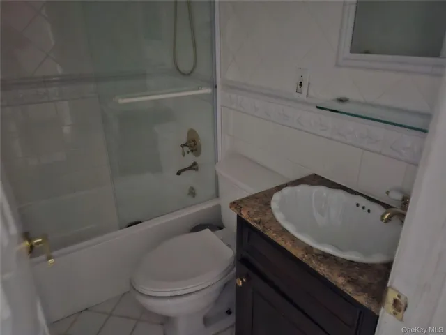 a view of an empty room with wooden floor and a fireplace