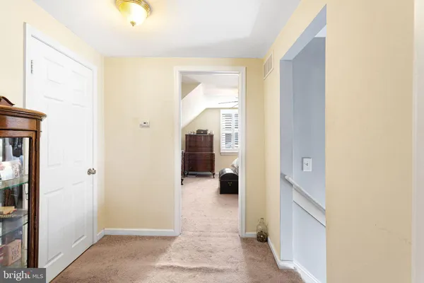 a view of a hallway with wooden shelves