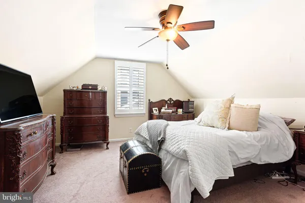 a bedroom with bed and a chandelier
