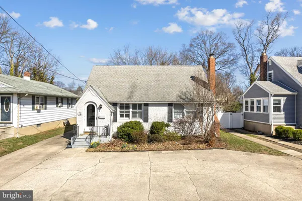 a front view of a house with a yard and potted plants