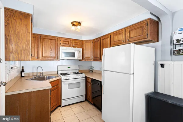 a white refrigerator freezer sitting in a kitchen
