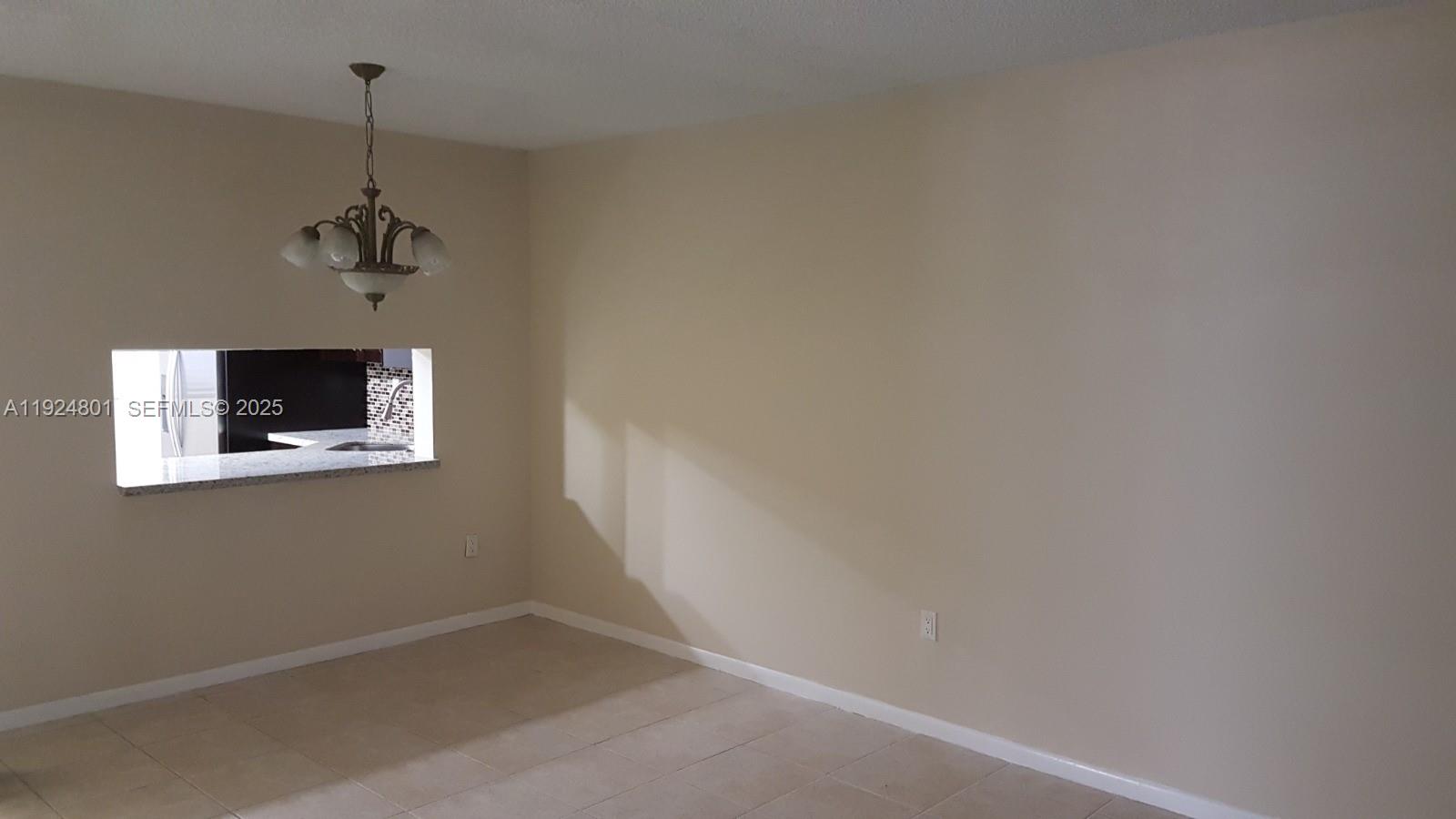 15969 Northwest 64th Avenue, Unit 105 Miami Lakes, FL 33014 - Photo 2 of 9 a view of a hallway with a small space