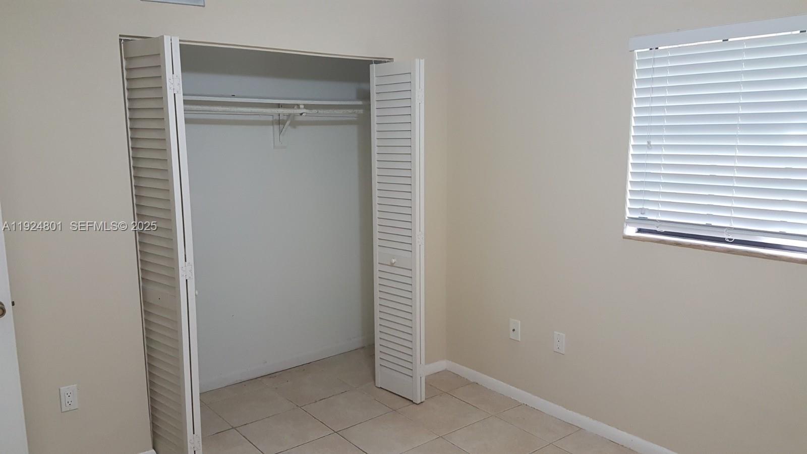 15969 Northwest 64th Avenue, Unit 105 Miami Lakes, FL 33014 - Photo 5 of 9 a view of an empty room