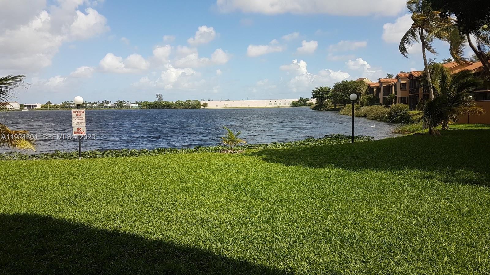 15969 Northwest 64th Avenue, Unit 105 Miami Lakes, FL 33014 - Photo 7 of 9 a view of a backyard with a garden