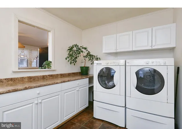 a utility room with sink dryer and washer