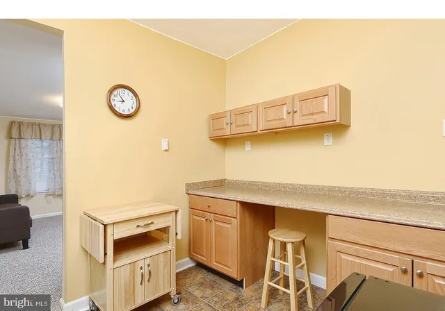 a kitchen with a refrigerator and cabinets