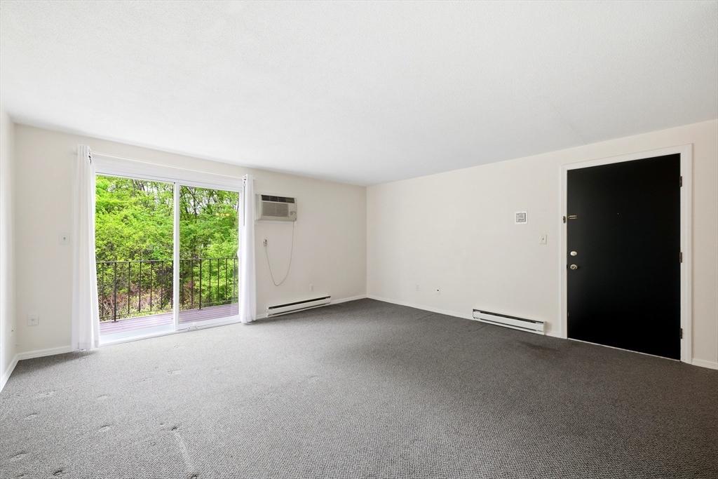 80 Damon Road, Unit 2303 Northampton, MA 01060 - Photo 5 of 23 a view of an empty room with a window