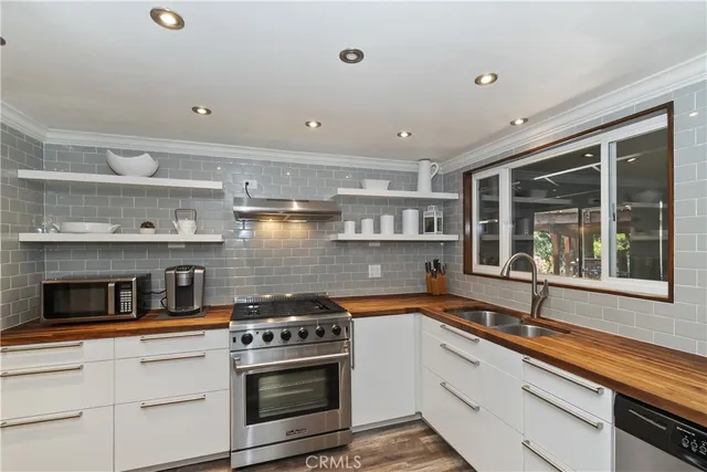 a kitchen with stainless steel appliances granite countertop a stove and a sink