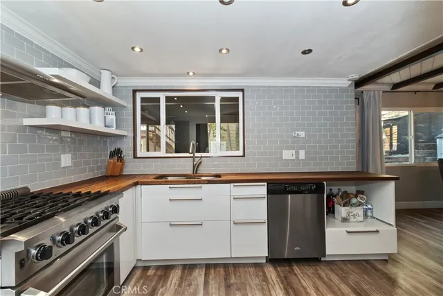 a kitchen that has a sink and a stove