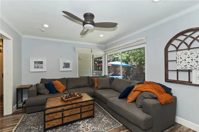 a living room with furniture ceiling fan and a window