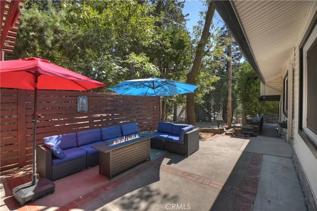 a view of a patio with a table and chairs under an umbrella